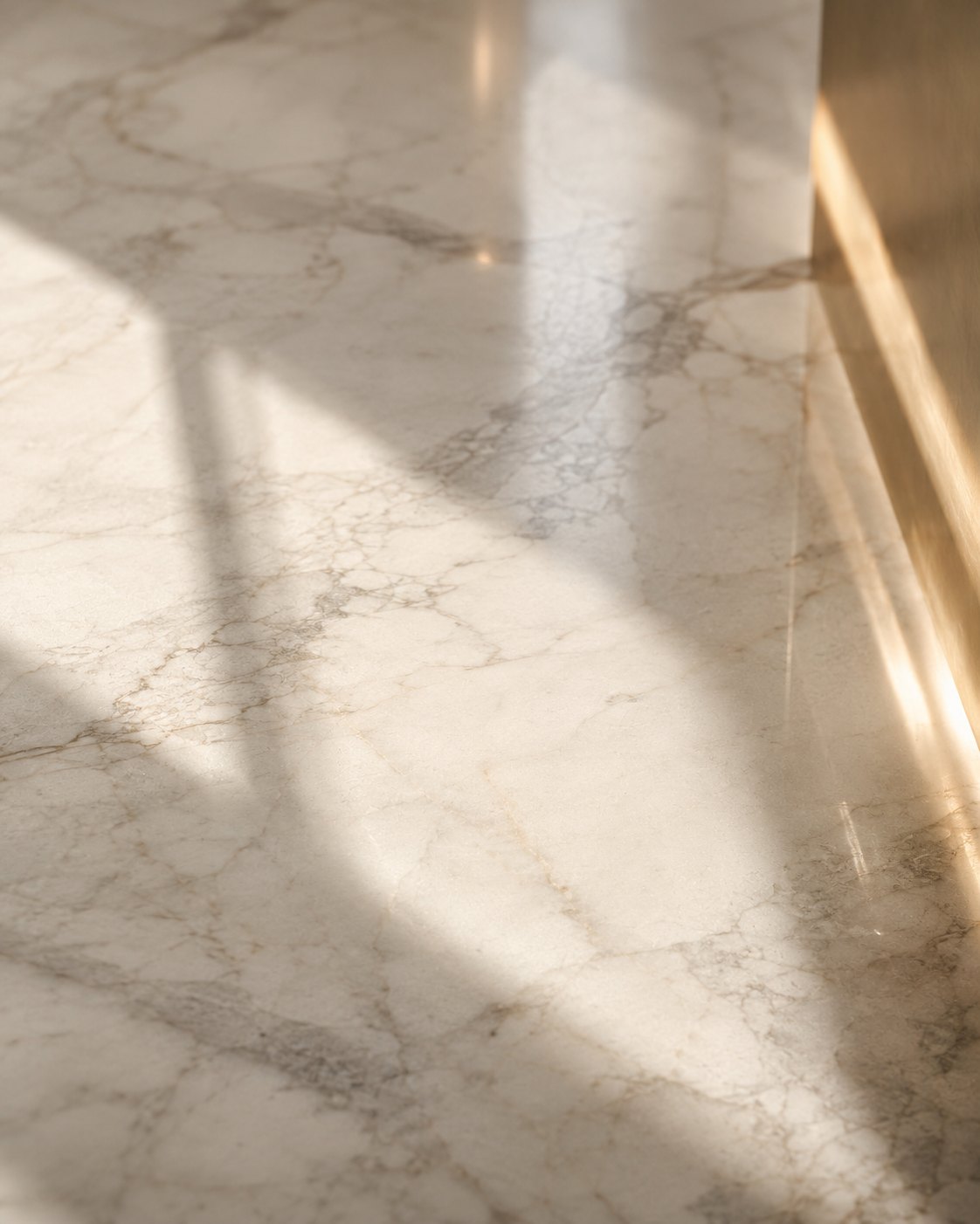 Soft window light falling across a pale marble surface