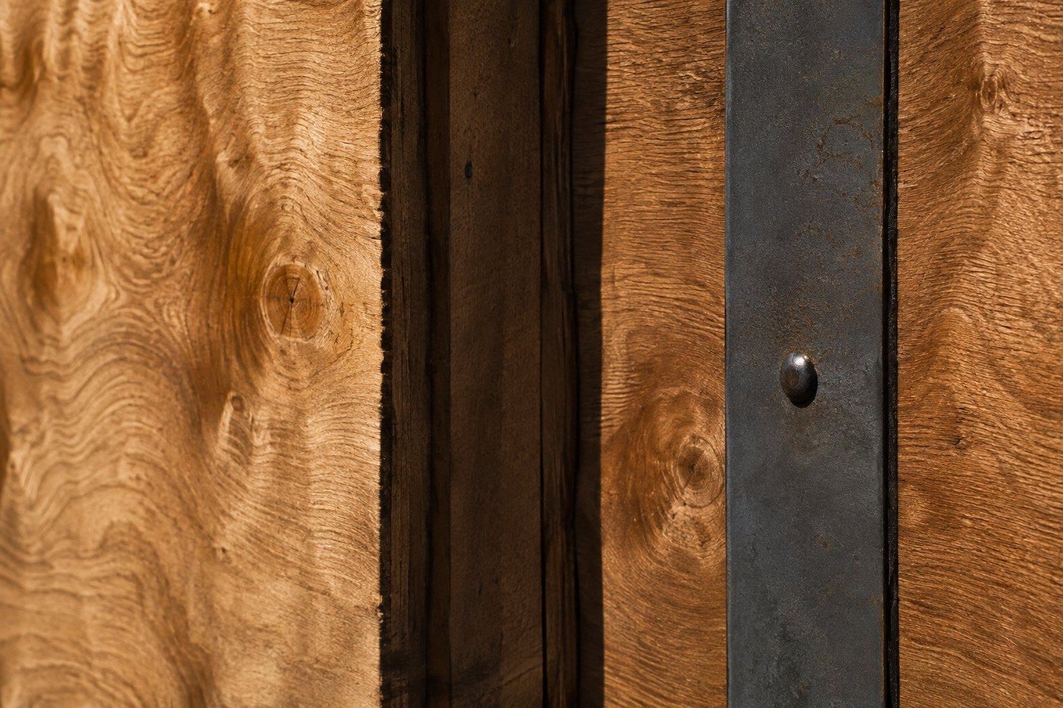 Macro detail of the plywood grain and steel banding of a sealed storage vault